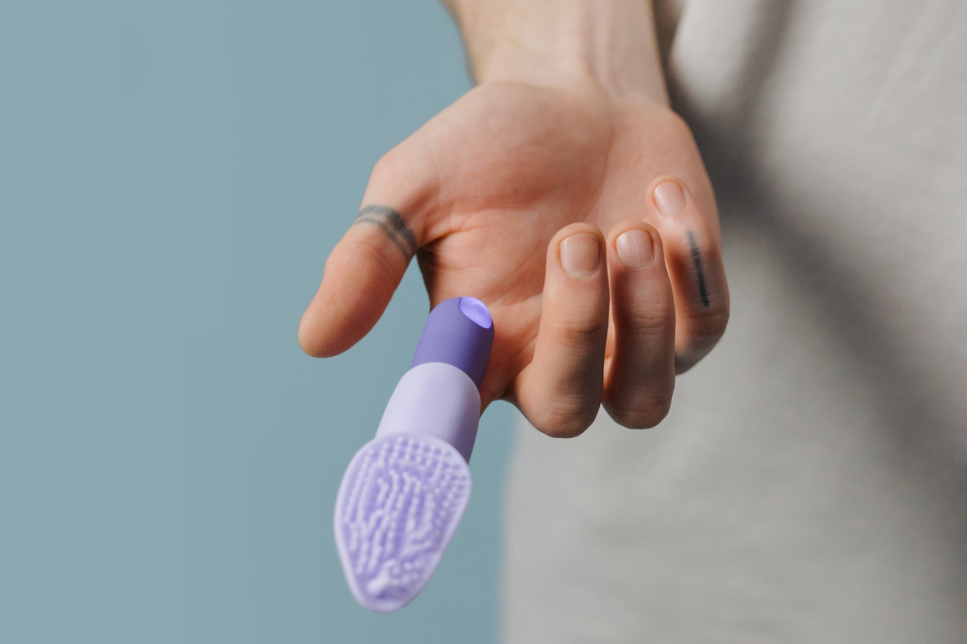purple finger vibrator in the person s finger